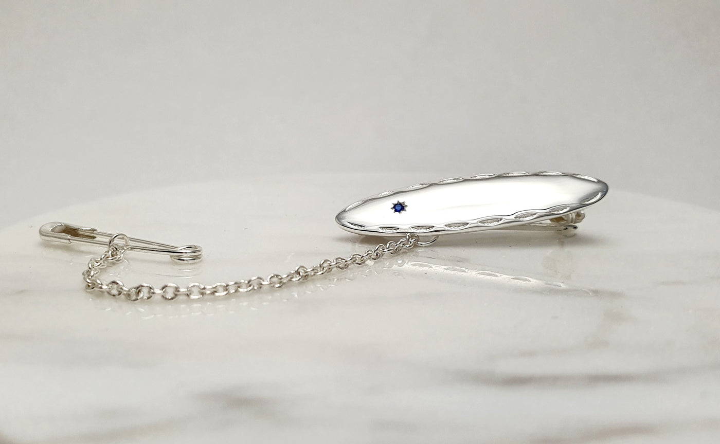 STERLING SILVER BABY BROOCH WITH BLUE STONE
